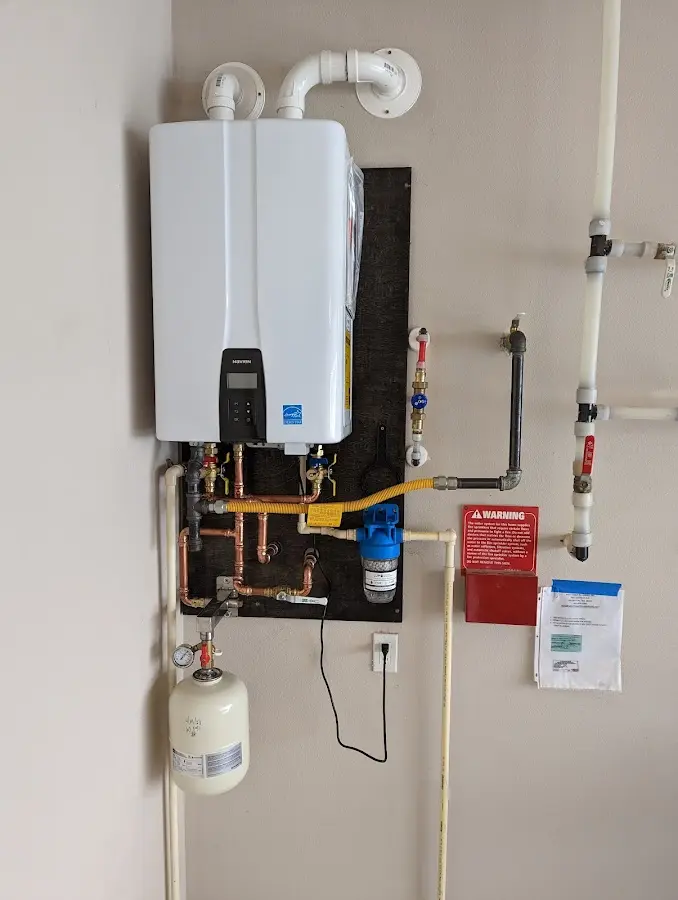 Professional plumber installing copper piping in a Corydon home